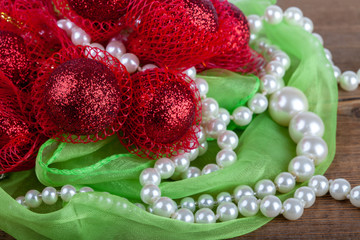 Pearls with creative Christmas decoration on a wooden background