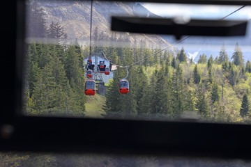 A gondola lift transporting people up and down a mountain.