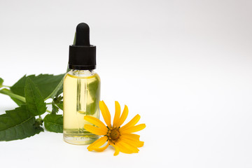 Herbal medicine dropper bottle with yellow flower. Cosmetic natural essential oil. Copy space
