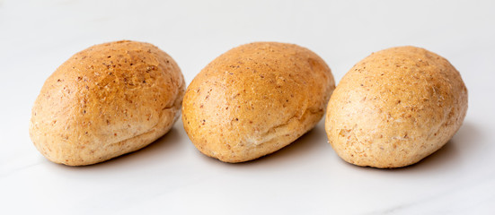 Graham buns on white background. Bakery products, whole wheat buns
