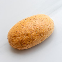 Graham bun on white background. Bakery products, whole wheat bun