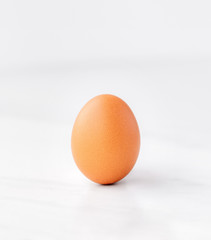 One egg on a white marble table