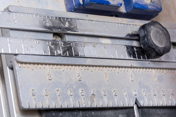 Tool cutter ceramic tiles close-up ruler without tiles. Construction equipment.