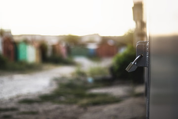 Padlock on a garage door in sunset light.