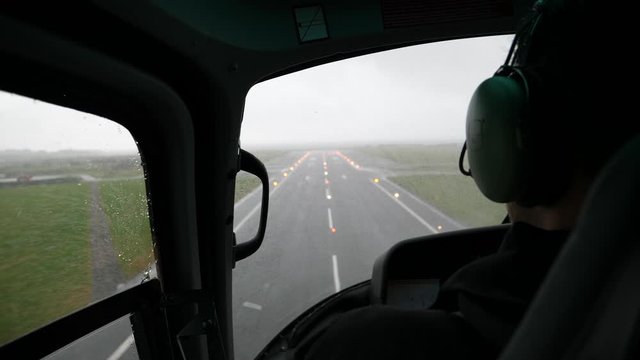 View from back seat of helicopter during a rainy and bumpy landing in Stavanger Norway