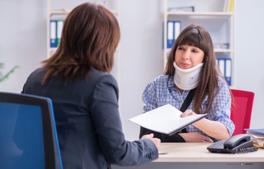 Injured employee visiting lawyer for advice on insurance