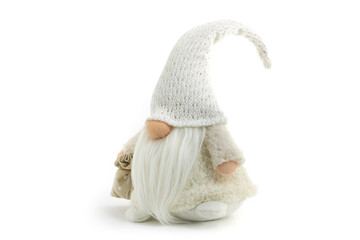 Gnome a beautiful Christmas elf in thick warm coat with gift bag standing with foot up on white...