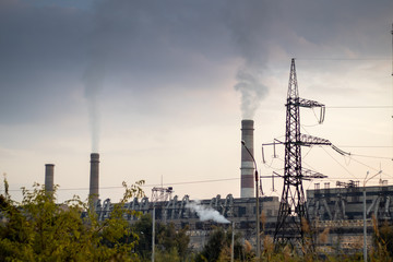 Thermal power plant with chimneys from which fumes thick smoke.