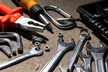 Various construction tools and devices lying on the floor. Close-up.