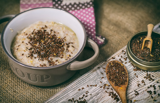 Oatmeal porridge bowl with flax linen seeds