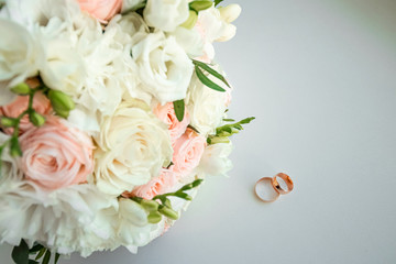 wedding rings and bridal bouquet. The concept of marriage, family relationships, wedding paraphernalia.