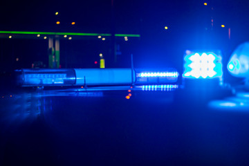 night time. blue police car with selective focus and blur bokeh.