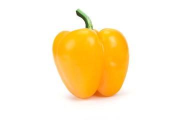 Perfect single yellow peppers isolated on a white background in close-up