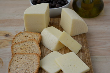 Typical cow cheese from Spain on a wooden board