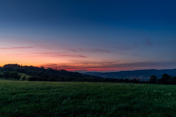 Multi colored sky of hill Velka Lhota Beskydy area sky and clouds play with many colors with view to surround the nature area around many small hills and mountains around capturing during sunset.