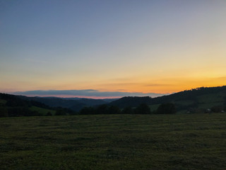 Multi colored sky of hill Velka Lhota Beskydy area sky and clouds play with many colors with view to surround the nature area around many small hills and mountains around capturing during sunset.