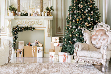 Christmas morning. Classic luxurious apartments with decorated christmas tree and presents. Living with fireplace, columns and stucco.