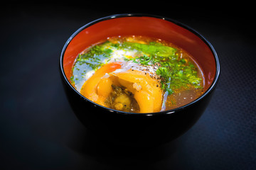 Bell pepper stuffed with meat and rice on a dark background.