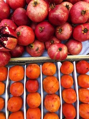 Fresh persimmons and pomegranates on the market