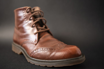 Vintage brown boots on black background, retro shoes