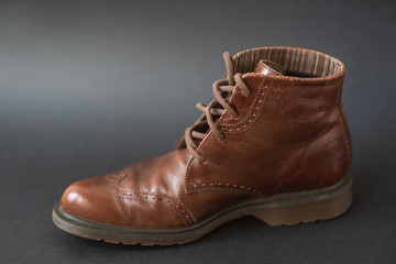 Vintage brown boots on black background, retro shoes