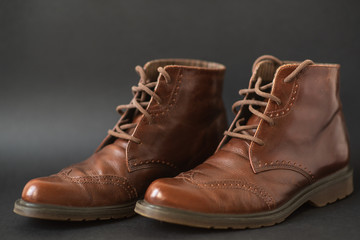 Vintage brown boots on black background, retro shoes