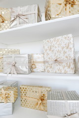 gifts in silver and gold paper on shelves
