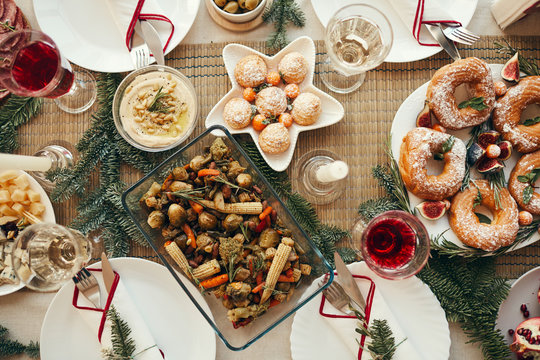 Above view background of beautiful Christmas table with delicious homemade food decorated with fir branches, copy space