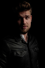 Obraz premium casual man wearing black leather jacket staring at camera seductive