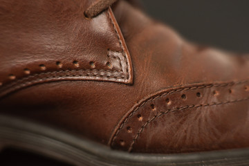 Vintage brown boots on black background, detail of retro shoes
