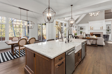 Beautiful kitchen in new traditional style luxury home, with quartz counters, hardwood floors, and stainless steel appliances - obrazy, fototapety, plakaty