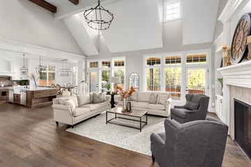 Fotobehang Hotel chique Beautiful living room and kitchen in new traditional style luxury home. Features vaulted ceilings, and elegant furnishings.. Lights are off.  © bmak