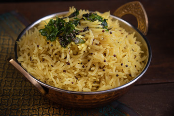 Indian lemon rice pilaf served in copper bowl