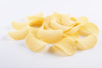 Crispy potato chips on white background.
