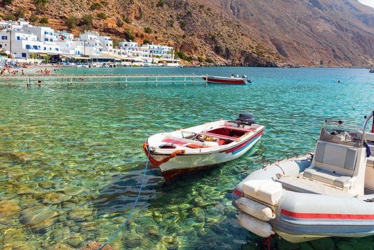 Small motorboat at clear water bay of Loutro town on Crete island, Greece