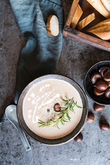 Creamy chestnut soup with sour cream in a ceramic bowl