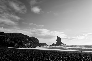 Djupalonssandur black beach in Snaefellsnes peninsula in Western Iceland in black and white long exposure on October evening.