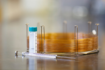 Syringe, vial, and GC capillary column used for separating volatile molecules.