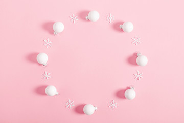 Christmas minimal composition. Wreath made of white decorations on  pastel pink  background. Christmas, New Year, winter concept. Flat lay, top view, copy space