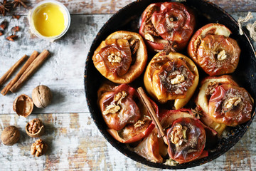 Baked apples with honey cinnamon and walnuts. Autumn food. Thanksgiving Dessert.