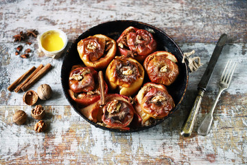 Baked apples with honey cinnamon and walnuts. Autumn food. Thanksgiving Dessert.