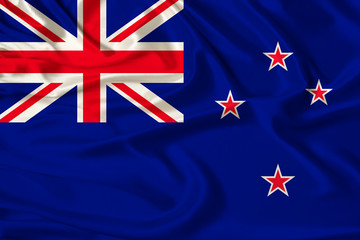 beautiful photograph of the New Zealand national flag on delicate shiny silk with soft draperies, the concept of state power, country life, horizontal, close-up, copy space