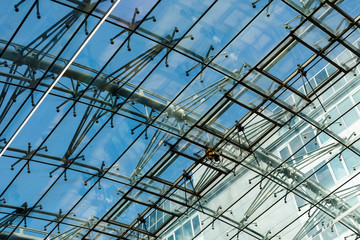 Fragment of a futuristic airport dome made of metal and glass.