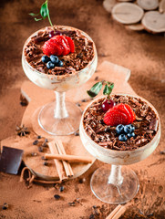 italian dessert tiramisu with strawberry in an elegant cocktail glass, the concept of sweet life, luxury, delicious food