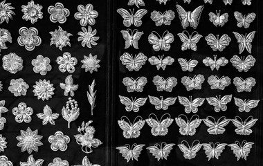 Silver butterfly and flower brooches on sale. Shop display