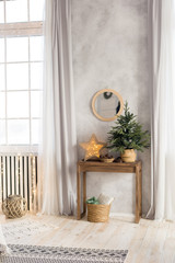 new year's interior. mirror on the wall above the table. Christmas tree on the table. nightlight in the form of stars