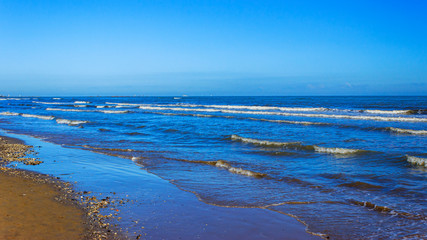 small waves on the sea coast in sunny weather