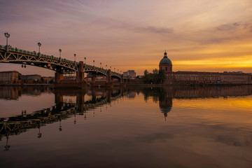 View of Chapelle Saint-Joseph and bridge Pont Saint-Pierre from the square Place Saint-Pierre at Sunset in Toulouse France