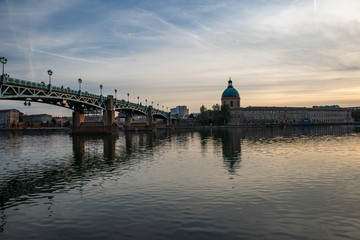 View of Chapelle Saint-Joseph and bridge Pont Saint-Pierre from the square Place Saint-Pierre at Sunset in Toulouse France