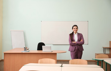 Portrait of female teacher in modern classroom